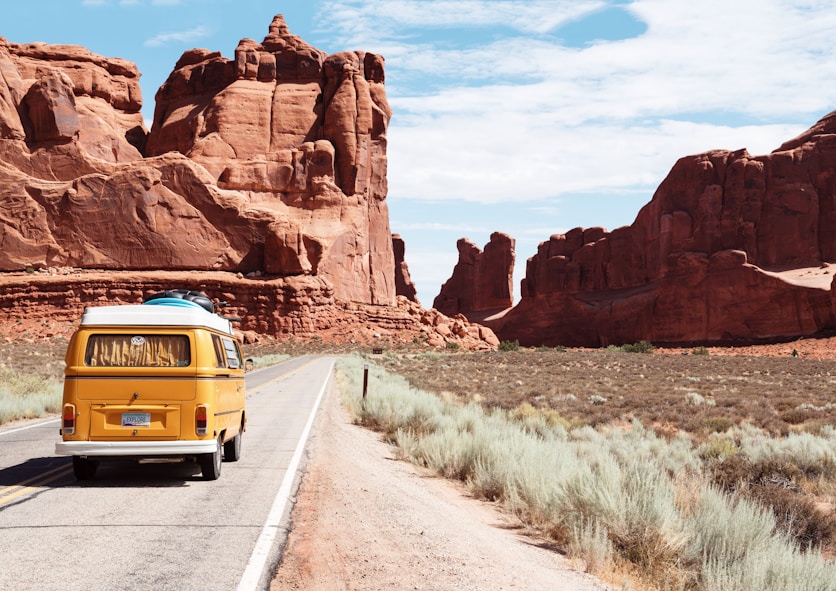 Yellow camper van traveling through canyons